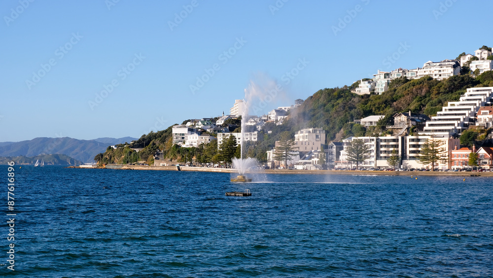 Scenic view of water fountain spraying in harbour of Oriental Bay in capital city of Wellington, New Zealand Aotearoa Scenic view of water fountain spraying in harbour of Oriental Bay in capital city of Wellington, New Zealand Aotearoa