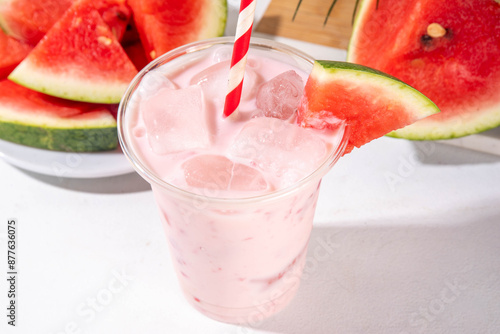 Fotografie Tasty sweet watermelon milkshake or creamy slushie cocktail, garnished with wate