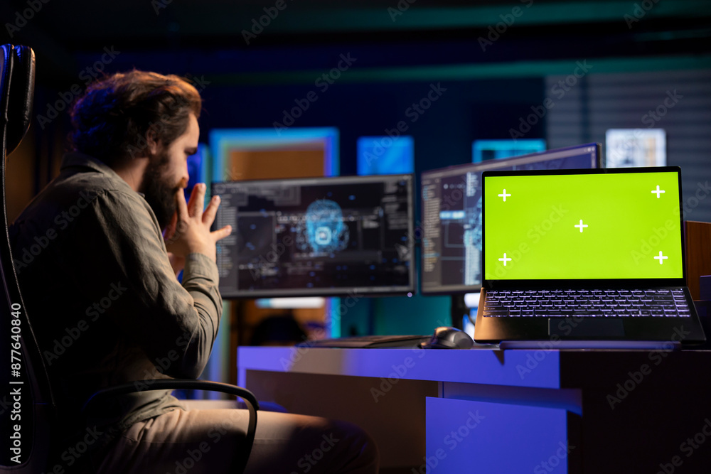 Green screen laptop next to programmer in home office staggered by AI gaining consciousness. Mockup notebook on desk next to computer scientist surprised by artificial intelligence turning autonomous Green screen laptop next to programmer in home office staggered by AI gaining consciousness. Mockup notebook on desk next to computer scientist surprised by artificial intelligence turning autonomous
