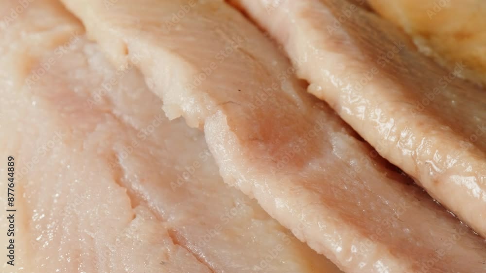 Raw herring fish slices a black plate close-up macro. Marinated herring fillet in oil and spices for appetizer. Raw seafood products Raw herring fish slices a black plate close-up macro. Marinated herring fillet in oil and spices for appetizer. Raw seafood products