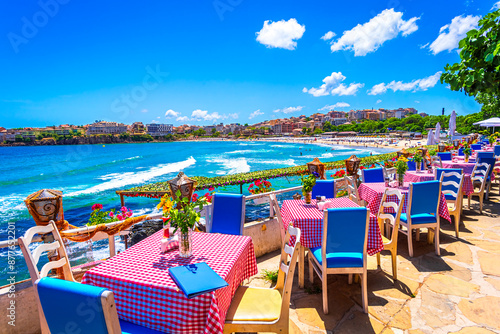 Sozopol, Burgas Province, Bulgaria: Empty tables on a terrace overlooking the sea. Cafe with sea view. Beautifull seascape at black sea. Summer destination
