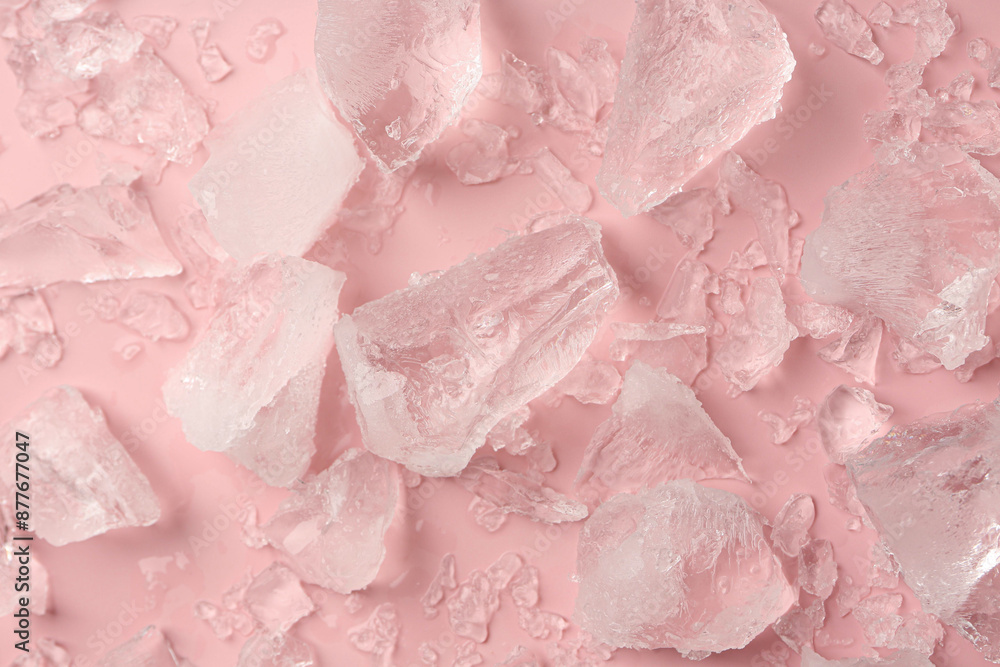 Pieces of crushed ice on pink background, top view Pieces of crushed ice on pink background, top view
