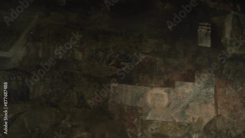 shooting of a faded ancient icon of the image of saints on the wall in the twilight of the church