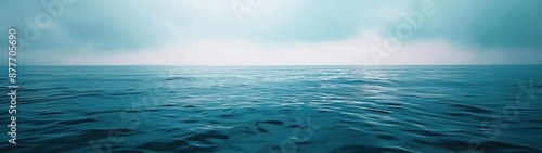 large body of water with a sky in the background