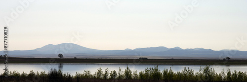 Ultra-wide panorama of dawn light on Lake Thirteen at Maxwell National Wildlife Refuge in New Mexico