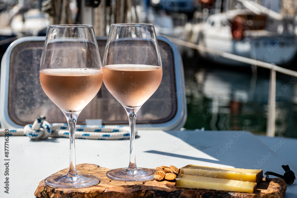 Party with rose wine on yacht boat anchored in port la Rague, Gulf of La Napoule, in Provence, two glasses of cold rose wine, French Riviera near Cannes, south of France Party with rose wine on yacht boat anchored in port la Rague, Gulf of La Napoule, in Provence, two glasses of cold rose wine, French Riviera near Cannes, south of France