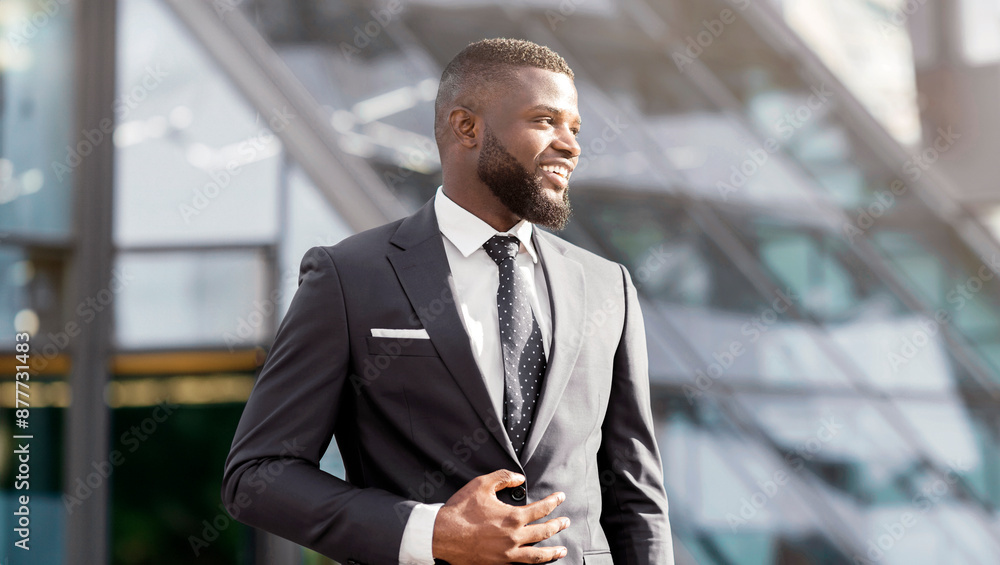 Smiling African American Business Guy Looking Aside Posing Against Office Building. Empty Space, Shallow Depth. Smiling African American Business Guy Looking Aside Posing Against Office Building. Empty Space, Shallow Depth.