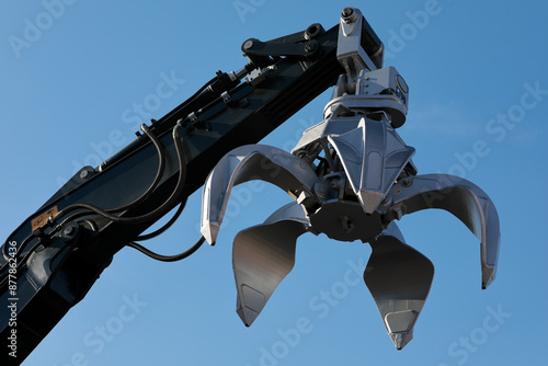 excavator arm with metal scrap grabber