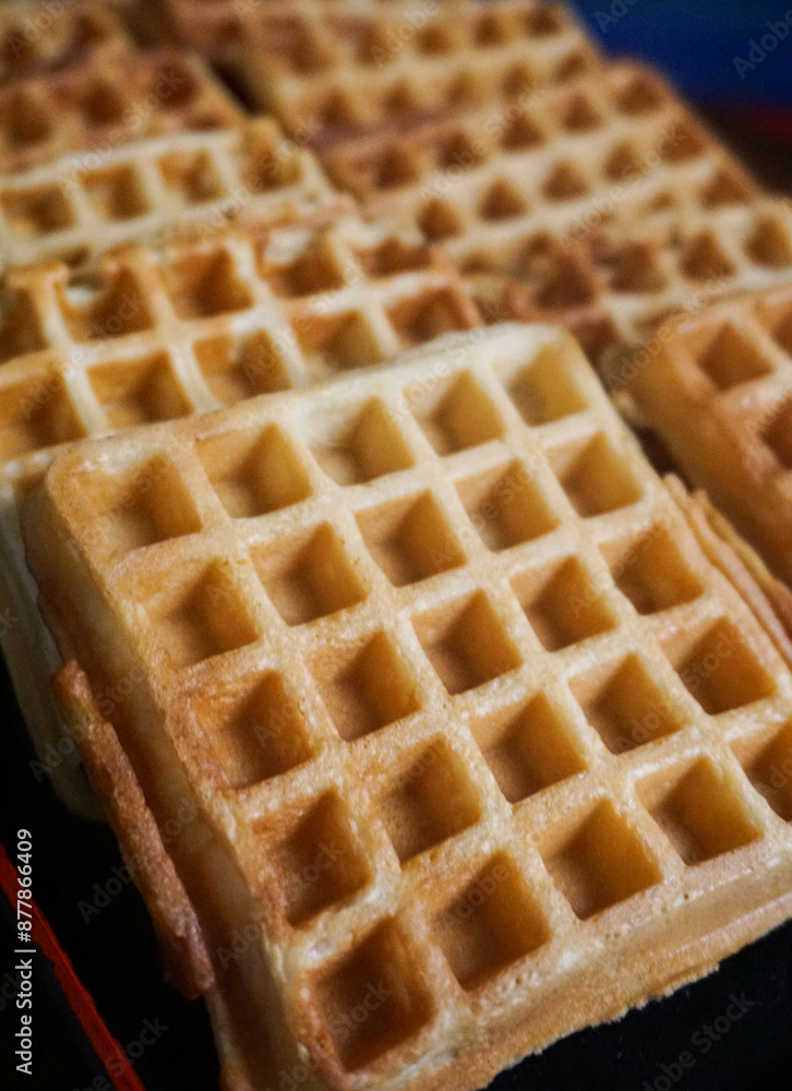 Homemade Waffles, delicious, close up. Waffle is a dish made from leavened batter or dough that is cooked between two plates that are patterned to give a characteristic size, shape, and surface impres Homemade Waffles, delicious, close up. Waffle is a dish made from leavened batter or dough that is cooked between two plates that are patterned to give a characteristic size, shape, and surface impres