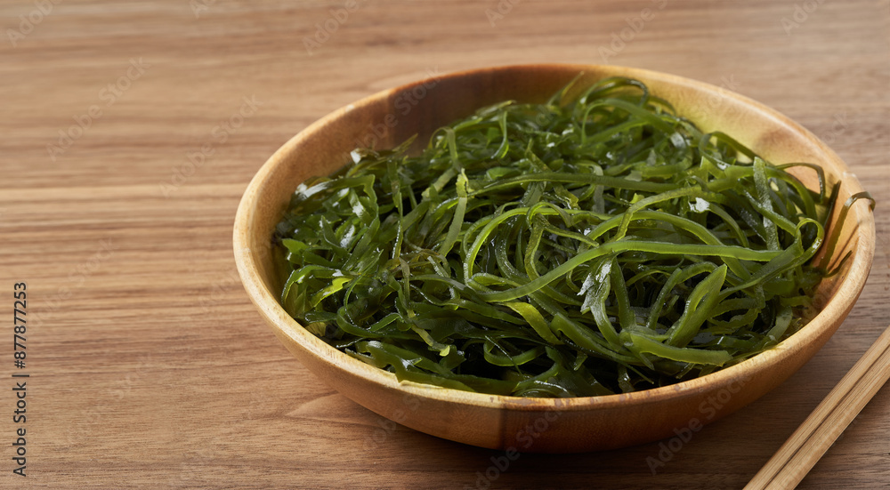 kelp seaweed laminaria strip in wooden bowl on wood table food background with copy space kelp seaweed laminaria strip in wooden bowl on wood table food background with copy space