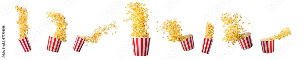 Flying popcorn from paper striped bucket isolated on black background
