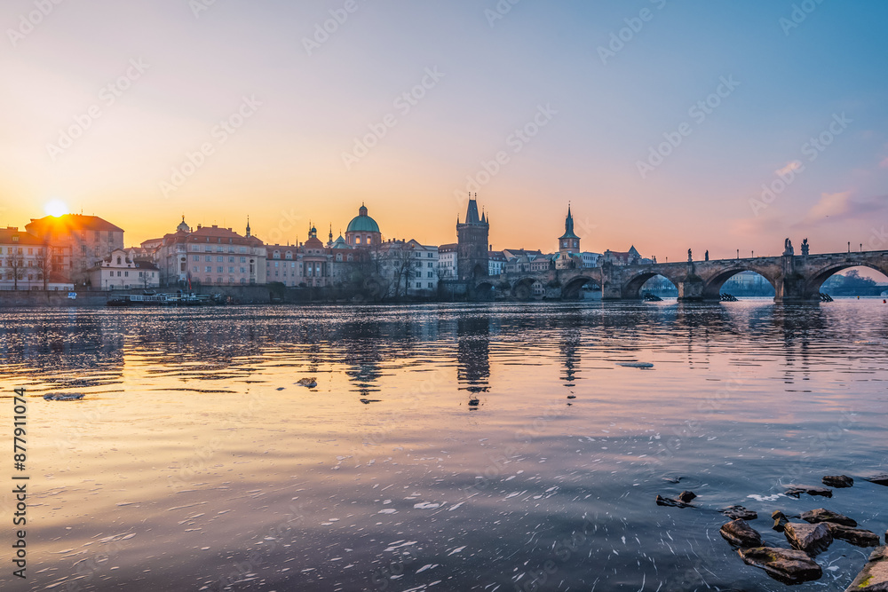 Fototapeta premium View of the city of Prague. Vltava river with Old Town Bridge Tower on Charles bridge in Prague, Czech Republic.