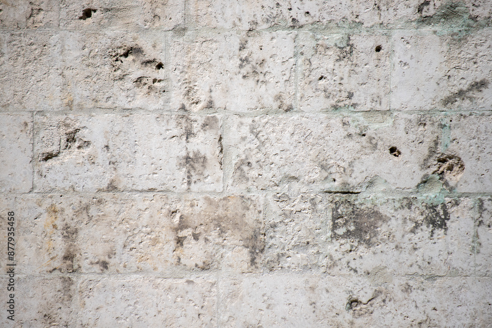 Old white wall in plaster with cracks, building texture background. Old white wall in plaster with cracks, building texture background.