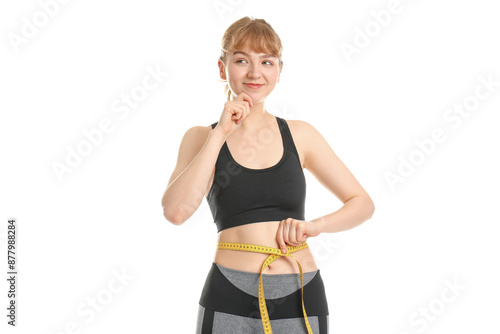Young woman measuring waist...