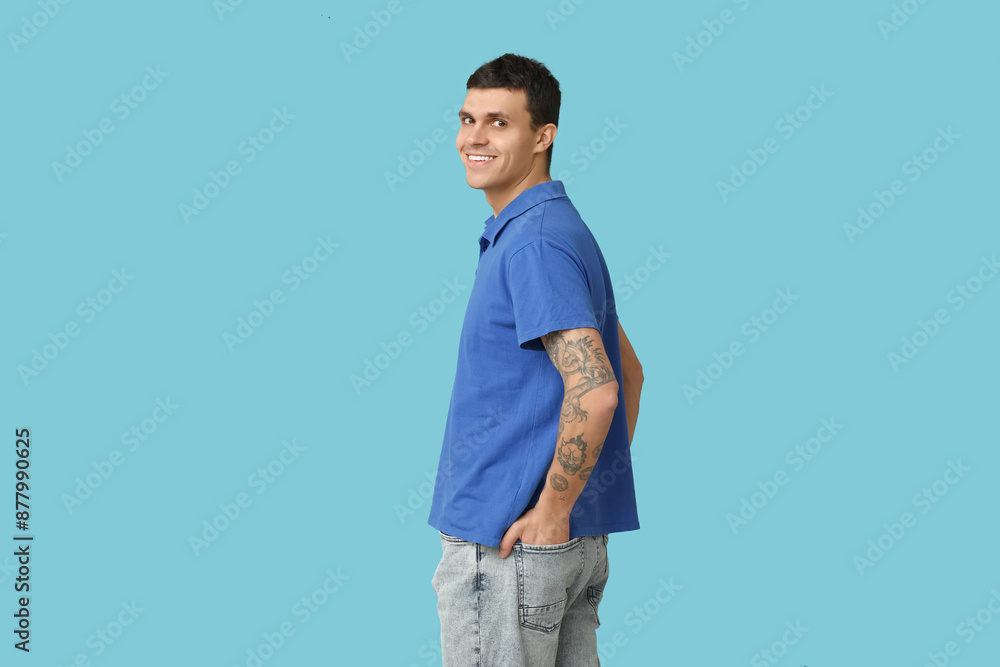 Fototapeta premium Handsome young man in stylish t-shirt on blue background