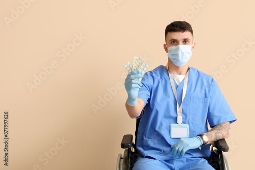 Young male doctor in wheelc...