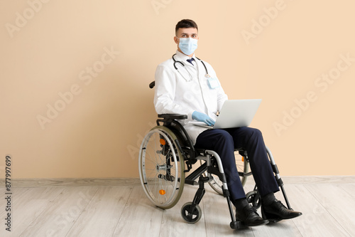 Young male doctor in wheelc...
