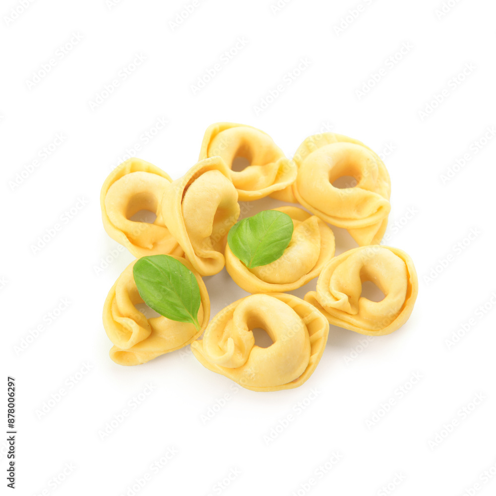 Raw dumplings and basil on white background Raw dumplings and basil on white background