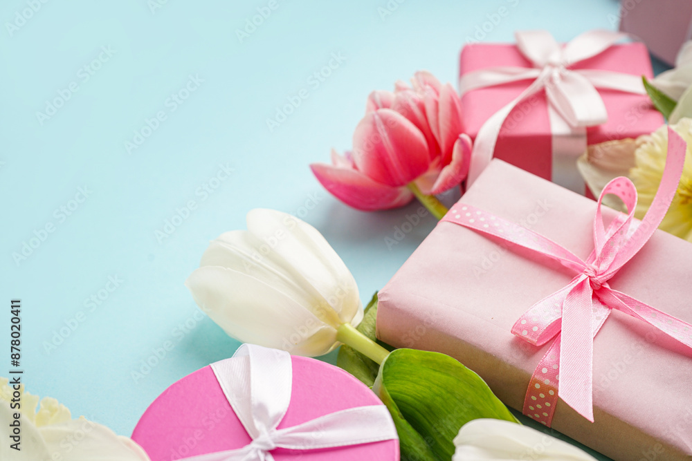 Gift boxes and beautiful tulips on blue background Gift boxes and beautiful tulips on blue background