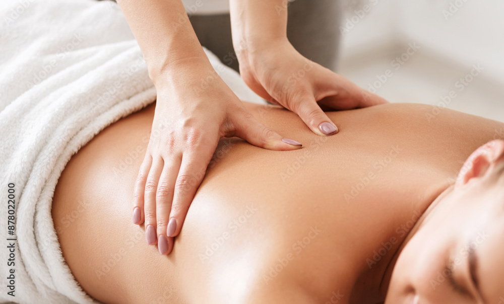 Body care. Young girl having massage, relaxing in spa salon, closeup Body care. Young girl having massage, relaxing in spa salon, closeup