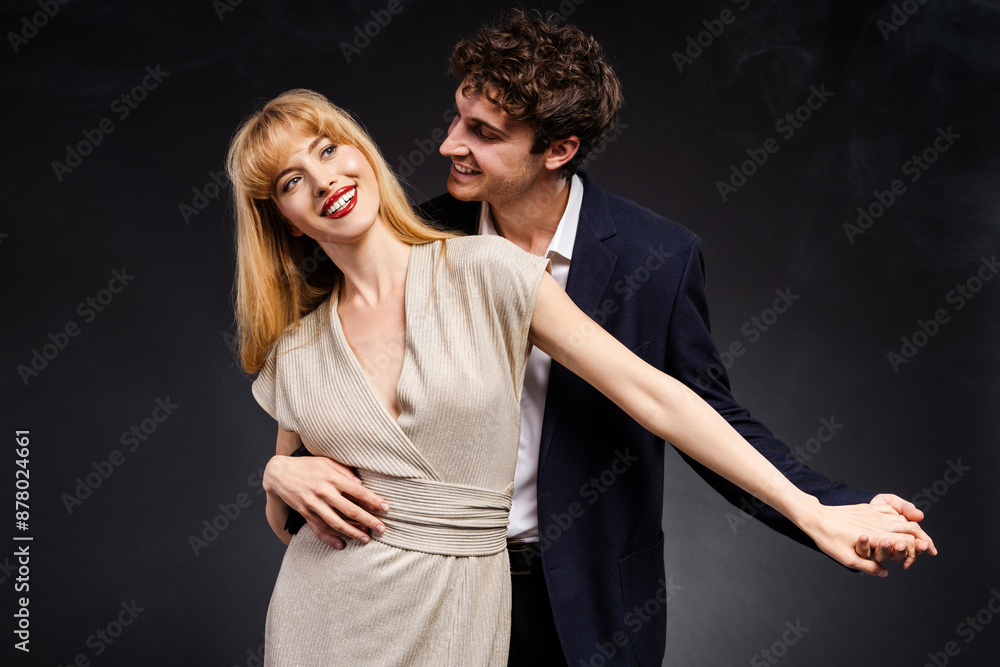 Fototapeta premium Elegant couple dancing together holding hands