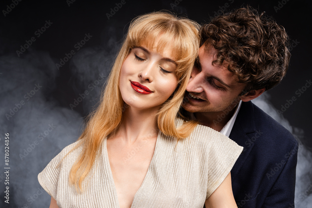 Man in a suit is kissing a woman with red lips Man in a suit is kissing a woman with red lips