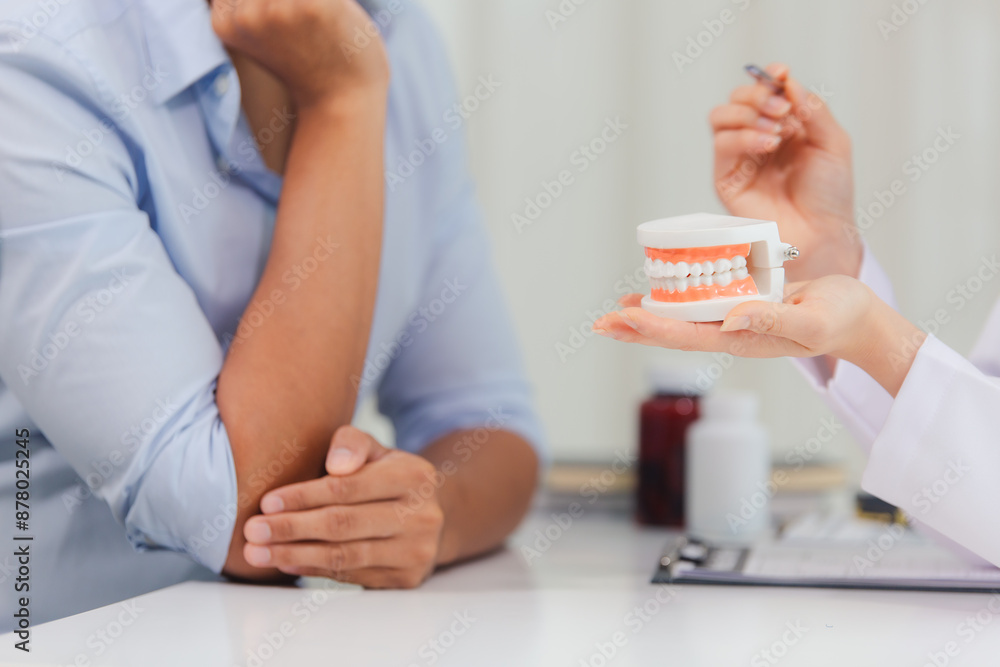 Fototapeta premium A man with a toothache saw a dentist at the clinic. To take care of his teeth and the dentist has advised him on how to care for and maintain his teeth. Dental treatment and diagnosis concepts
