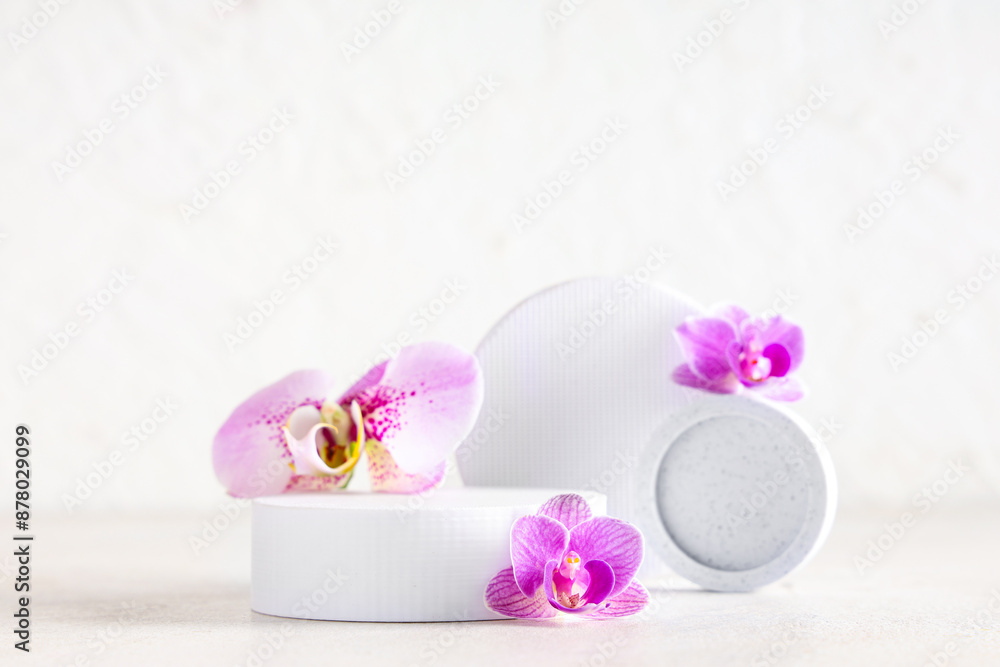 Decorative podiums with beautiful orchid flowers on white background Decorative podiums with beautiful orchid flowers on white background