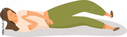 Young woman is lying on the floor, holding her stomach in pain
