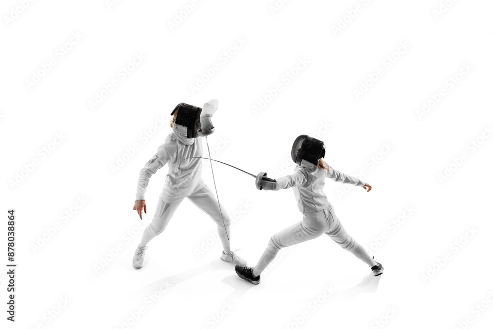 In fencing training session, two female competitors work on their attack and parry sequences against white studio background. Concept of professional sport, competition, strength and power, action. Ad In fencing training session, two female competitors work on their attack and parry sequences against white studio background. Concept of professional sport, competition, strength and power, action. Ad