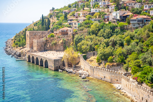 Fototapeta Naklejka Na Ścianę i Meble -  Ancient shipyard or Tersane near of Kizil Kule tower and beautiful beach and calm turquoise sea surface in Alanya, Turkey