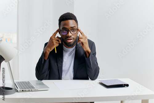 Fotografie Professional african american businessman working on laptop at office desk in co