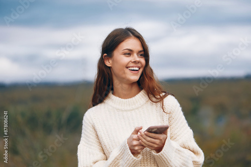 Mountain Freedom: Woman Smiling, Connecting in Nature's Adventures © SHOTPRIME STUDIO