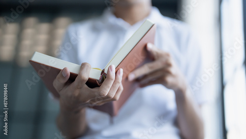 Man is engrossed in a book with a focused expression showcasing the joy and concentration of reading.