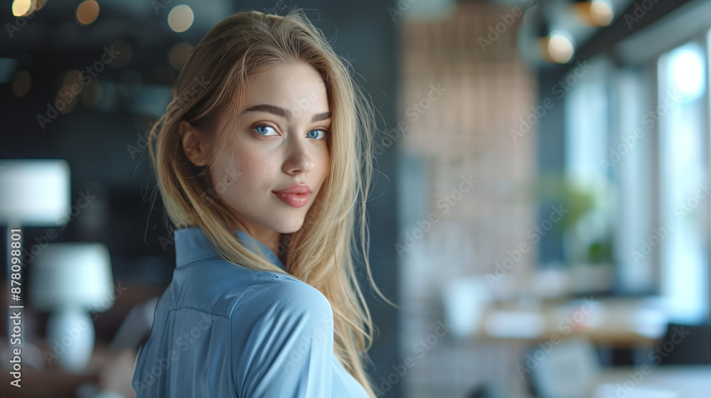 Young beautiful businesswoman in blue shirt in modern office Young beautiful businesswoman in blue shirt in modern office