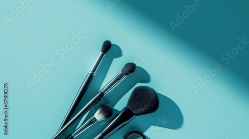 A set of makeup brushes are displayed on a blue background