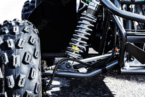 Wallpaper Mural A close up of a black off road vehicles suspension system. The image shows the large tire, a shock absorber, and part of the frame Torontodigital.ca