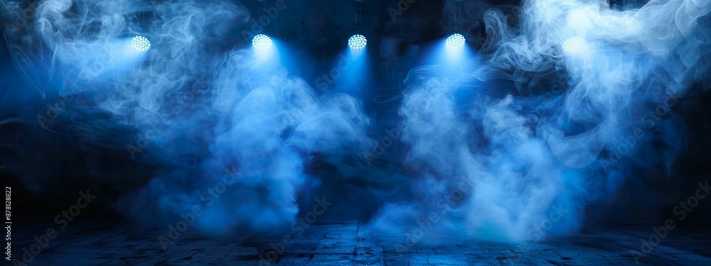 Naklejka premium Blue Smoke and Spotlights on Stage Creating Moody and Dramatic Atmosphere