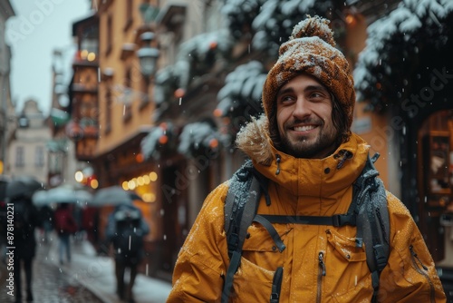 A man wearing a yellow jacket and winter hat stands on a bustling, snowy street with a cheerful smile, capturing the vibrant atmosphere and winter season.