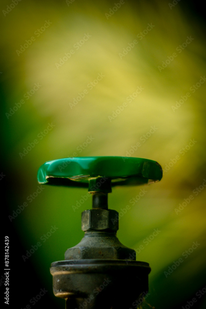 green faucet has a bokeh background green faucet has a bokeh background