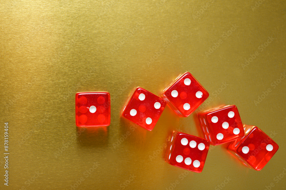 Close-up of a red dice on a golden table Close-up of a red dice on a golden table