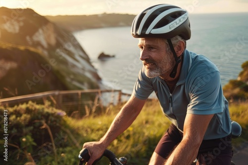 A man in a red jacket bikes along the coast at sunset, enjoying the beauty of nature and the stunning landscape AIG58 photo