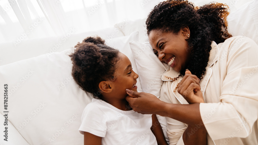 Mother and daughter bonding together in bed Mother and daughter bonding together in bed