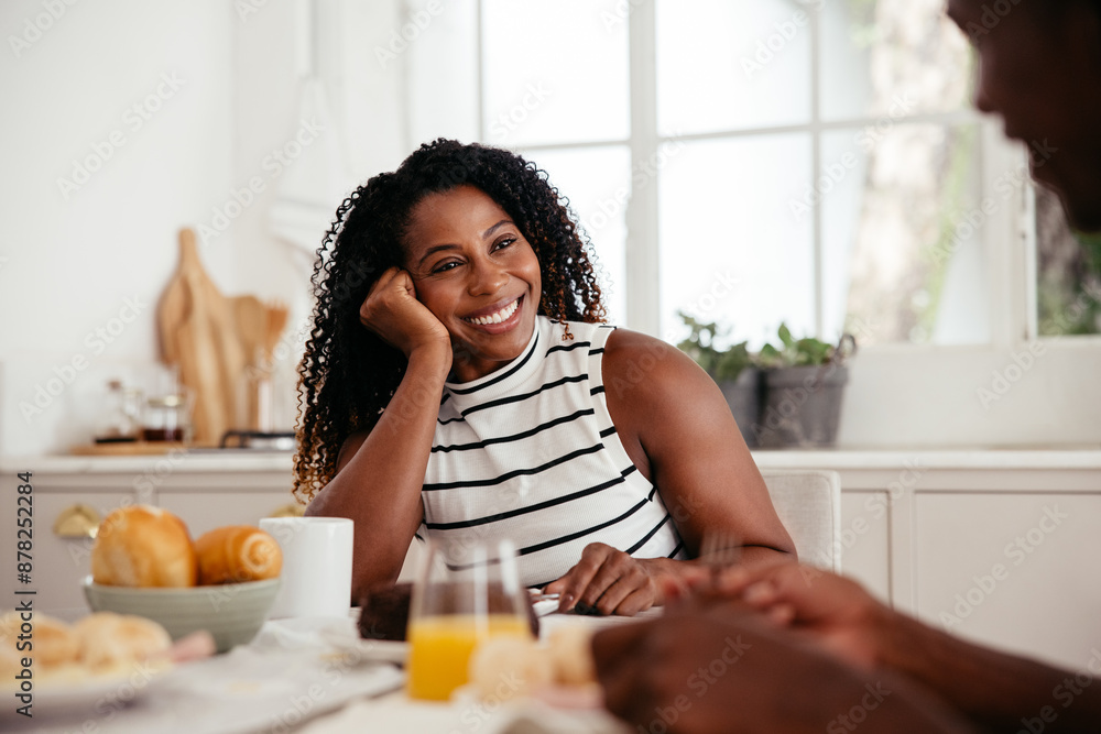 Woman enjoying a sunny breakfast with partner Woman enjoying a sunny breakfast with partner