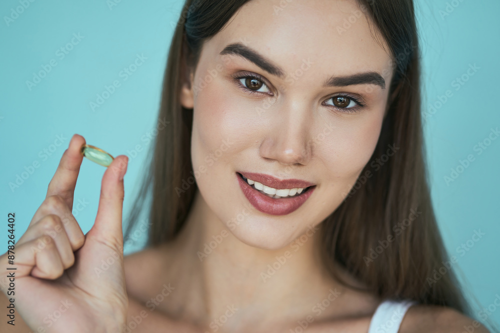 Woman Smiling And Holding Fish Oil Capsule Woman Smiling And Holding Fish Oil Capsule