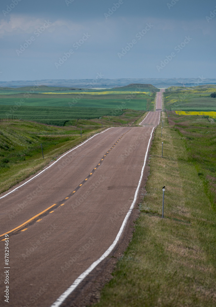 Rural highway through rolling hills near the town of Assiniboia, Saskatchewan, Canada Rural highway through rolling hills near the town of Assiniboia, Saskatchewan, Canada