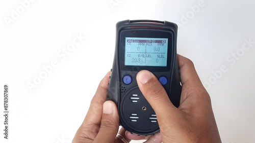 Using a portable gas detector to monitor the composition of the surrounding air or toxic gases (on a white background). Industrial action.