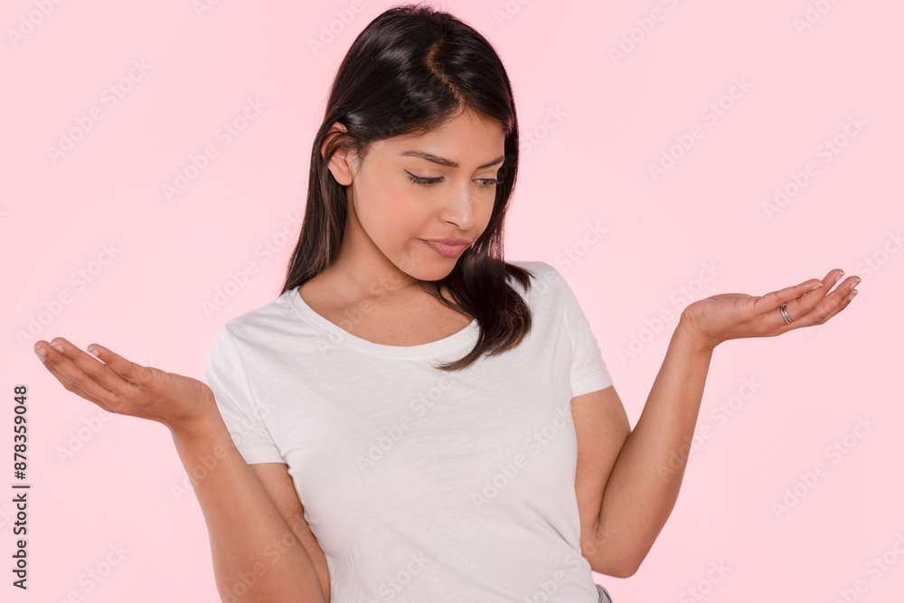 Young Woman Wearing White Shirt Gestures With Both Hands Against Pink Background Young Woman Wearing White Shirt Gestures With Both Hands Against Pink Background