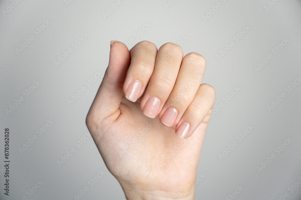 Close-up of woman's hands with neutral manicure. Showcasing natural Close-up of woman's hands with neutral manicure. Showcasing natural