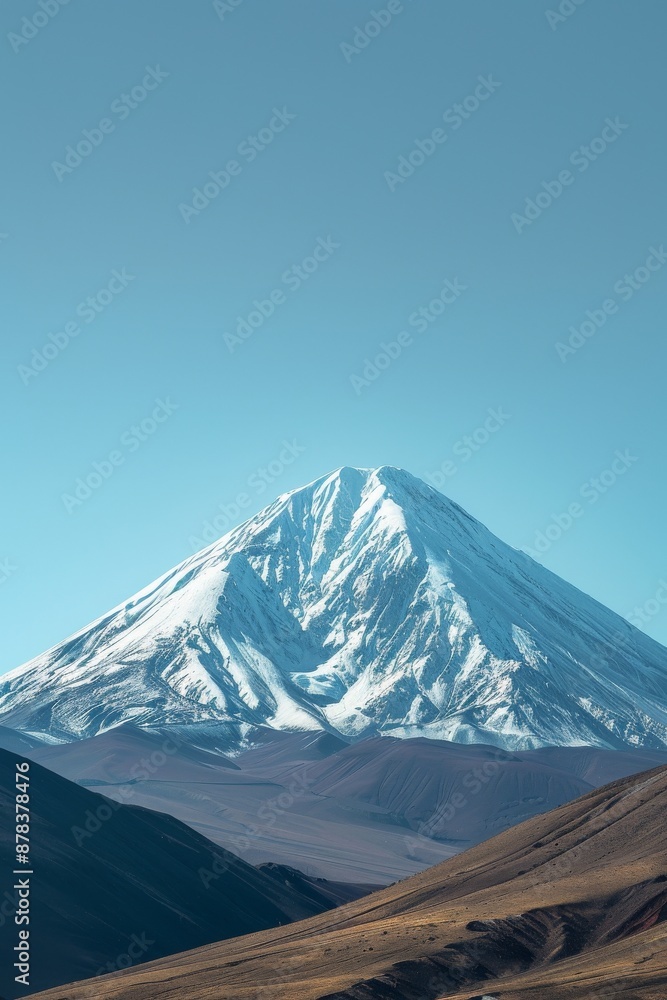 A majestic snow-capped mountain peak rises against a clear blue sky. The mountain is surrounded by rolling hills and valleys. A majestic snow-capped mountain peak rises against a clear blue sky. The mountain is surrounded by rolling hills and valleys.